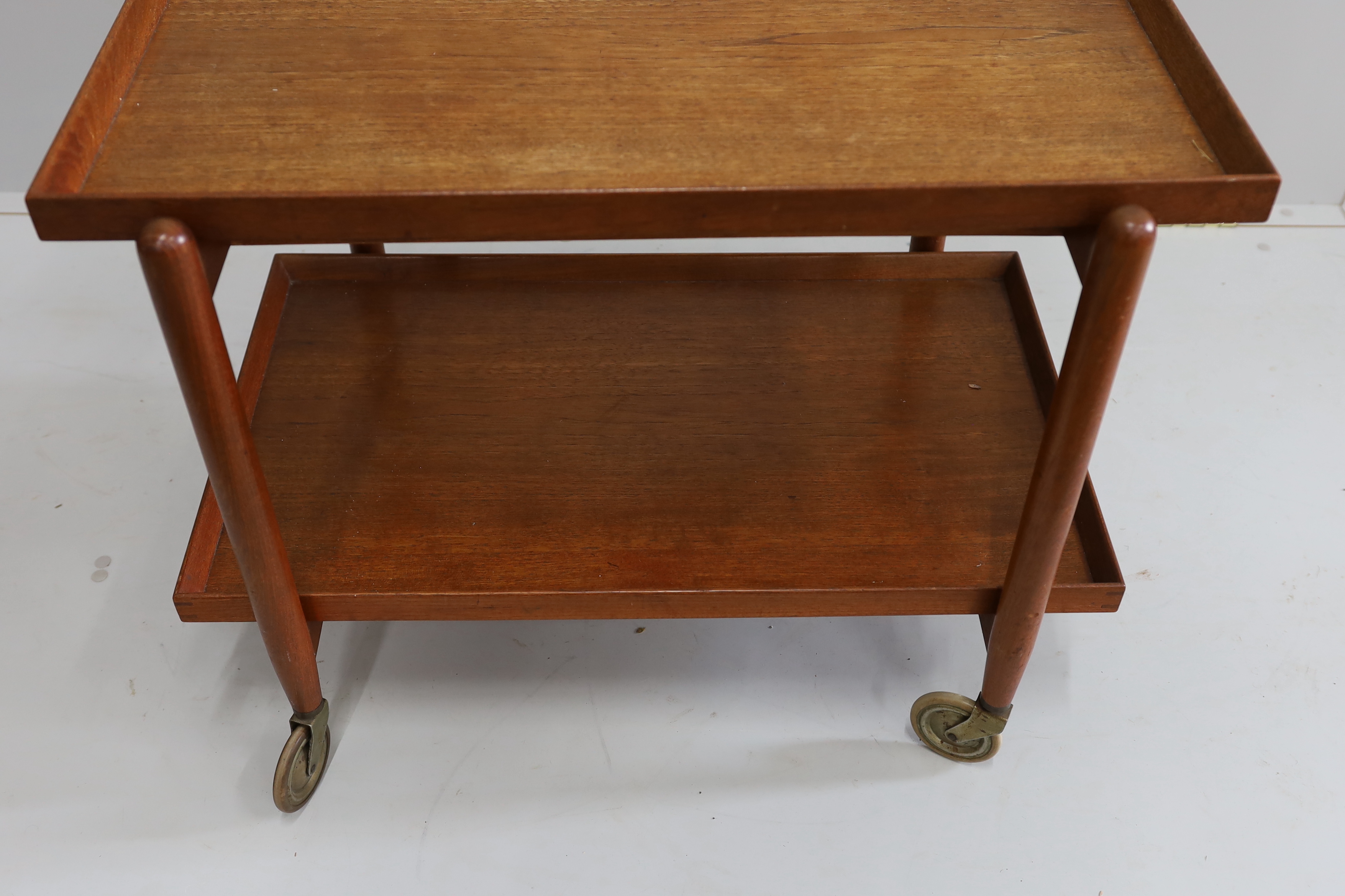 In the manner of Poul Hundevad, a mid century teak two tier tea trolley, width 75cm, depth 50cm, height 59cm